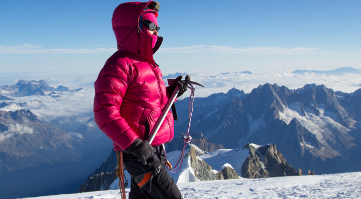 climber wearing down jacket on the mountains