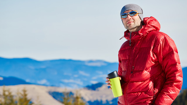 man wearing down jacket enjoying the outdoors