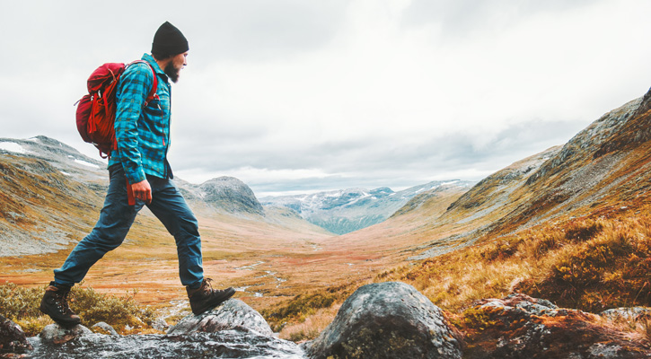 man hiking in mountain trail