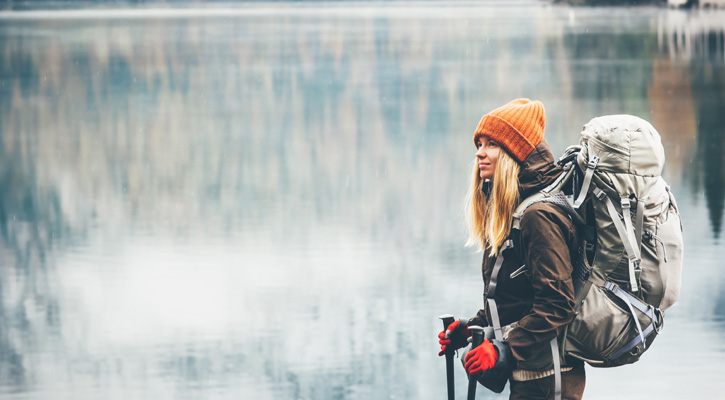 woman hiking wearing heavy backpack