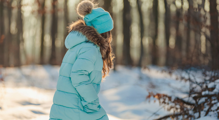 girl wearing down jacket in forest