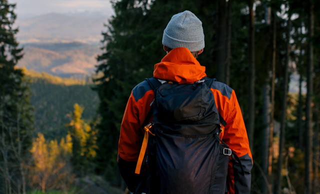 hiker with backpack in the woods