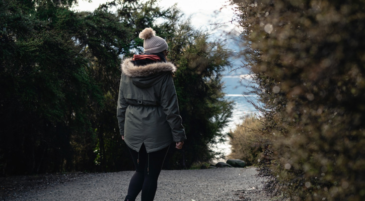 woman wearing winter parka in a forest