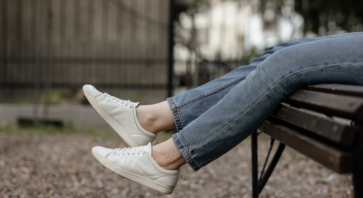 woman wearing white sneakers