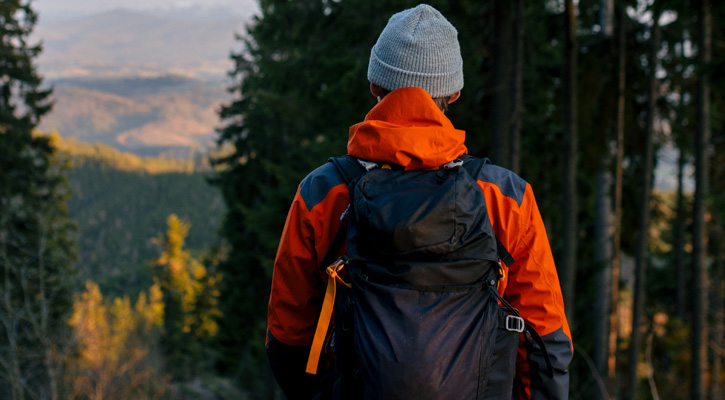 hiker with black backpack in the forest