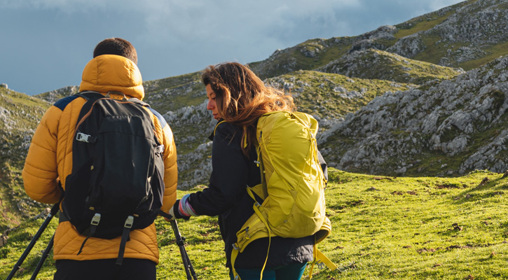 hikers with backpacks on a mountain trail