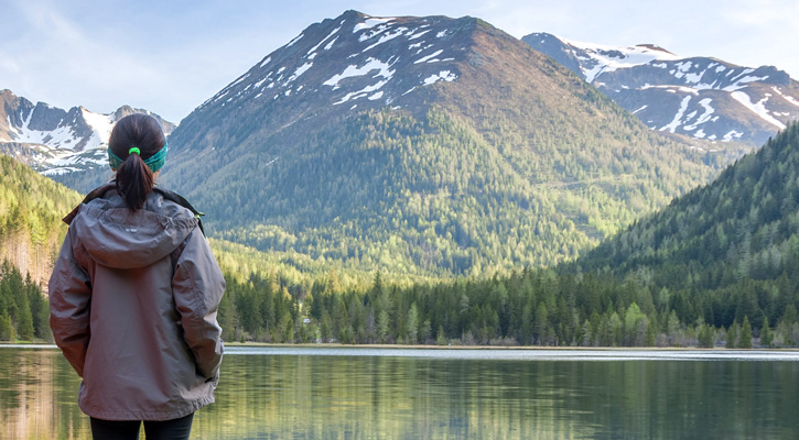 woman camping at a mountain lake