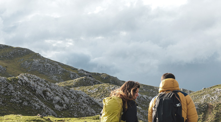 a couple hiking on green hills