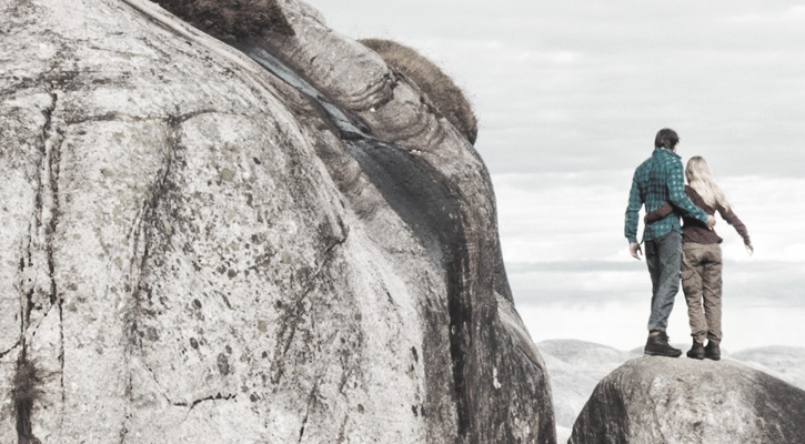 a couple hiking on top of a mountain