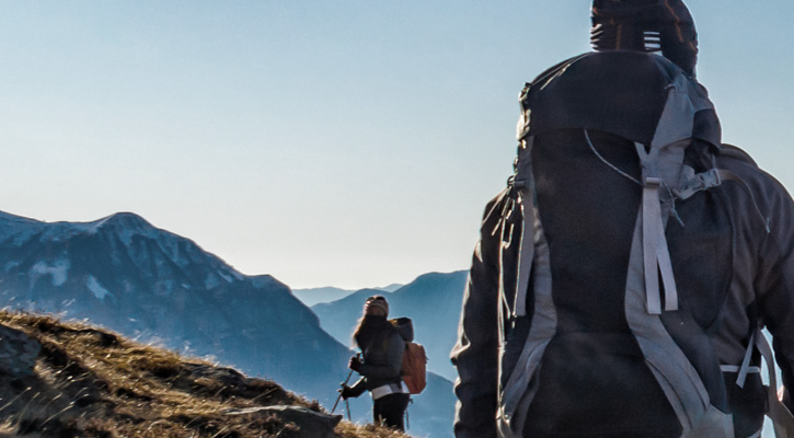 hikers wearing outdoor jackets in the mountains