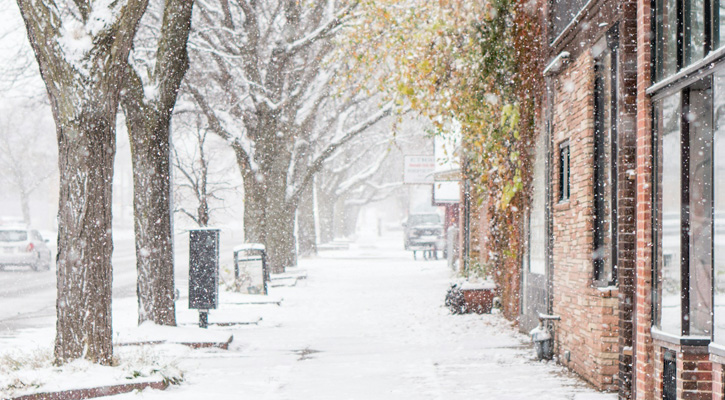 city street in winter snowing